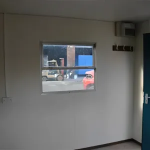 Anti-vandal break room cabin with sink, water heater, and worktop