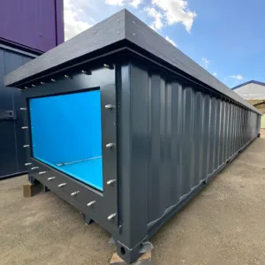 Modern shipping container swimming pool with tempered glass windows