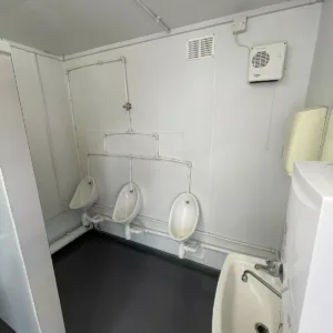 Portable toilet block container with wheelchair-accessible restroom compartment