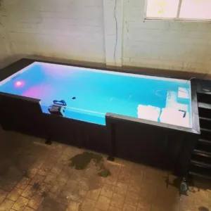Modern container swimming pool installed in a small outdoor space