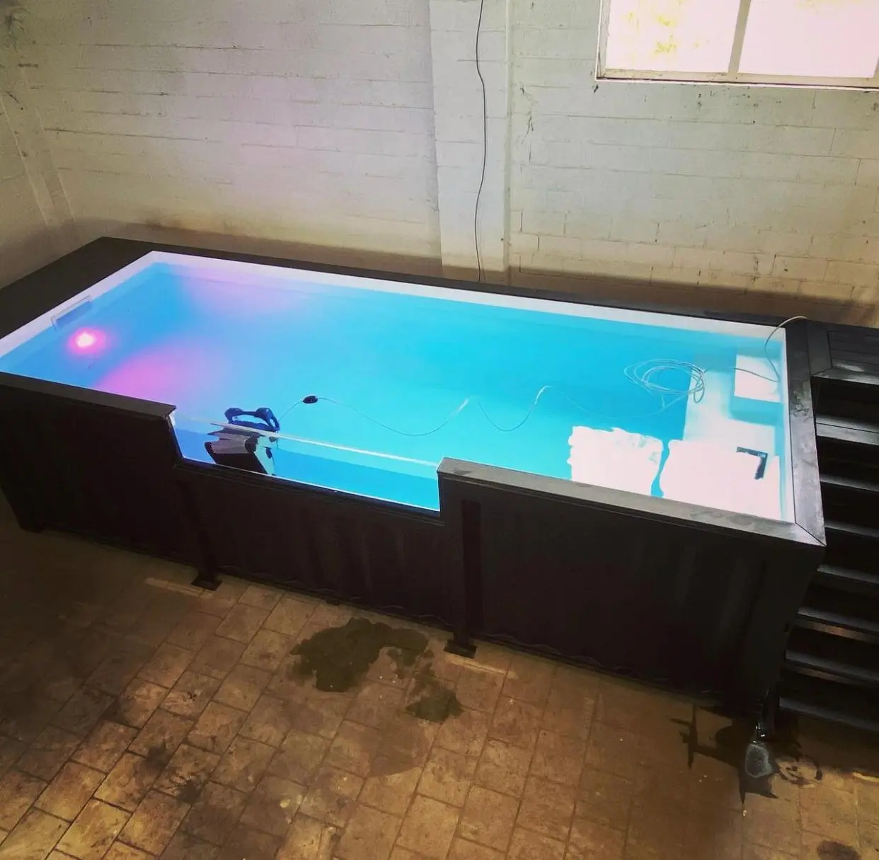 Modern container swimming pool installed in a small outdoor space