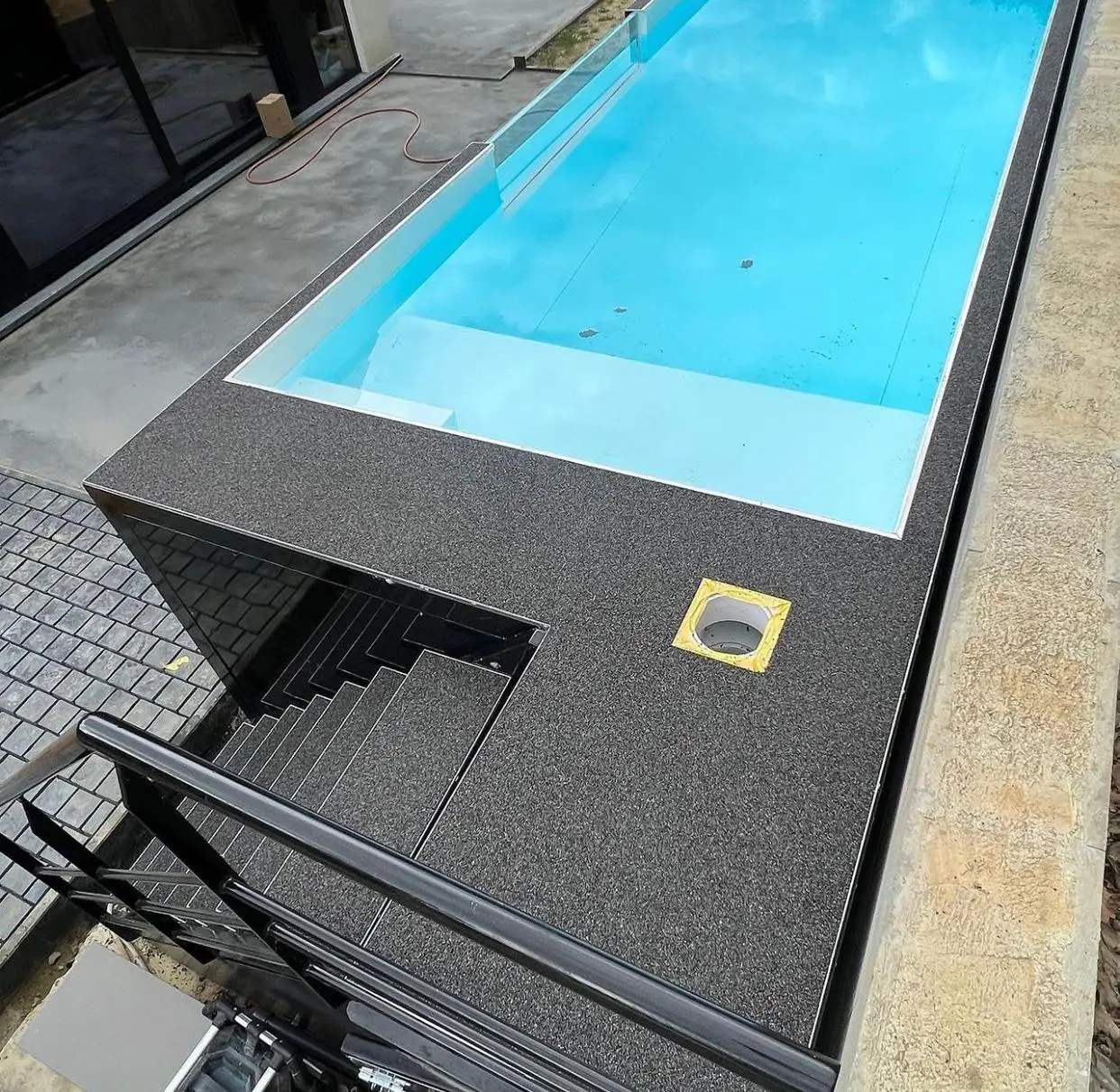 Custom 20ft container pool with built-in steps and seating bench