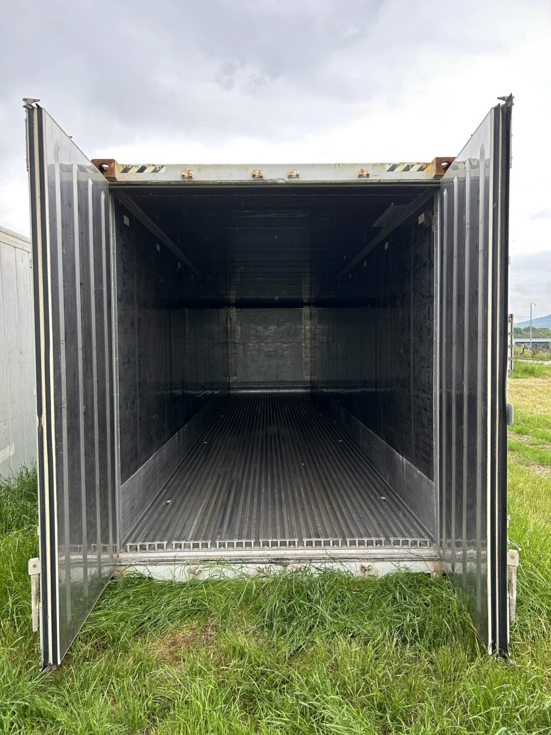Commercial refrigerated container with insulated walls and temperature control system