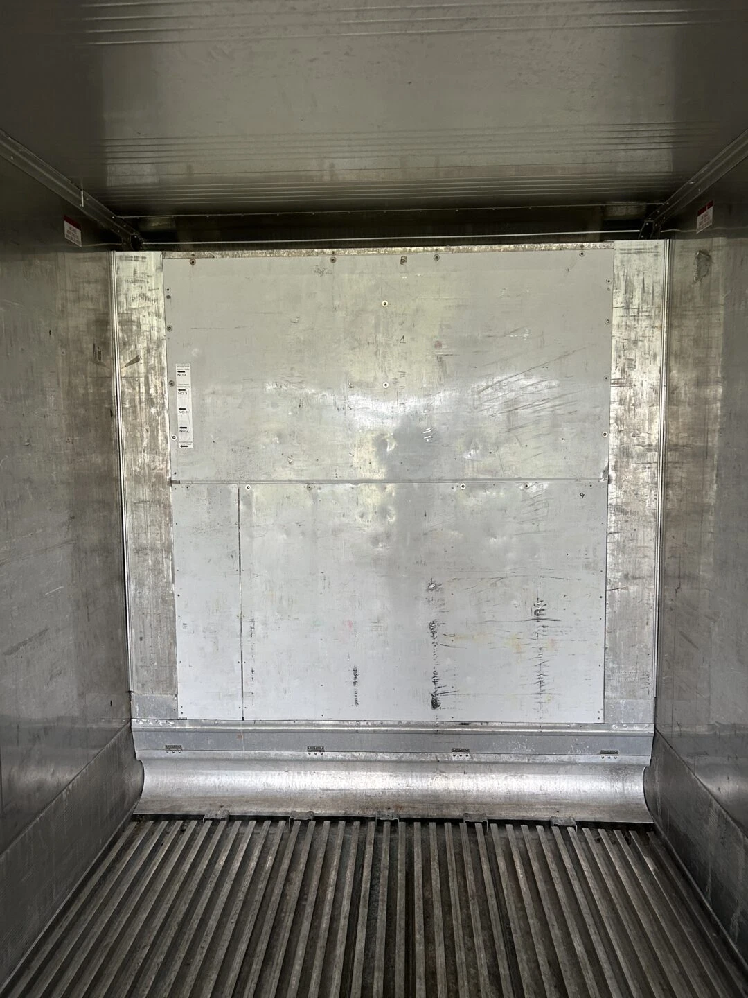 Refrigerated shipping container with secure cargo doors and insulated walls