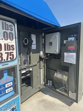 Self-service ice vending machine with purified water dispensing system