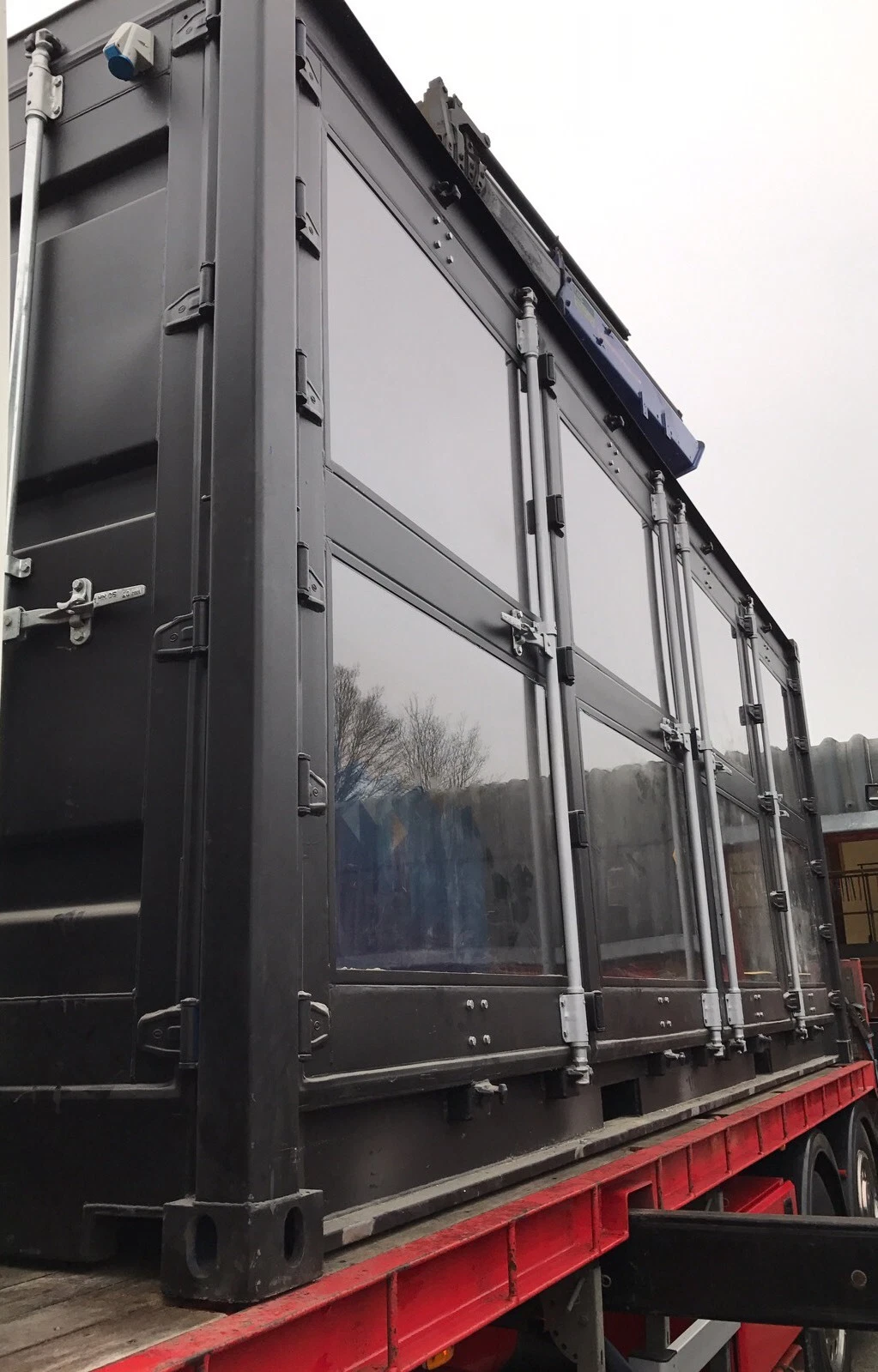 20ft shipping container converted into a workshop with glass windows