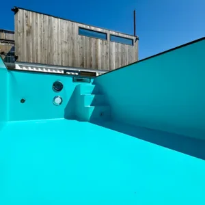 Portable outdoor swimming pool made from a modified shipping container