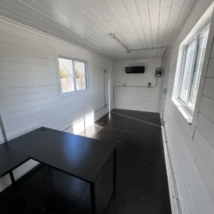 Portable shipping container office with shiplap walls and energy-efficient mini split