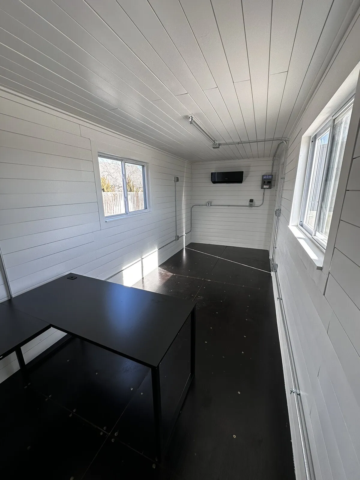 Portable shipping container office with shiplap walls and energy-efficient mini split