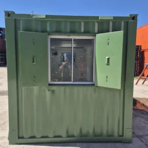 Open-plan container office with windows, electrical installation, and secure steel door