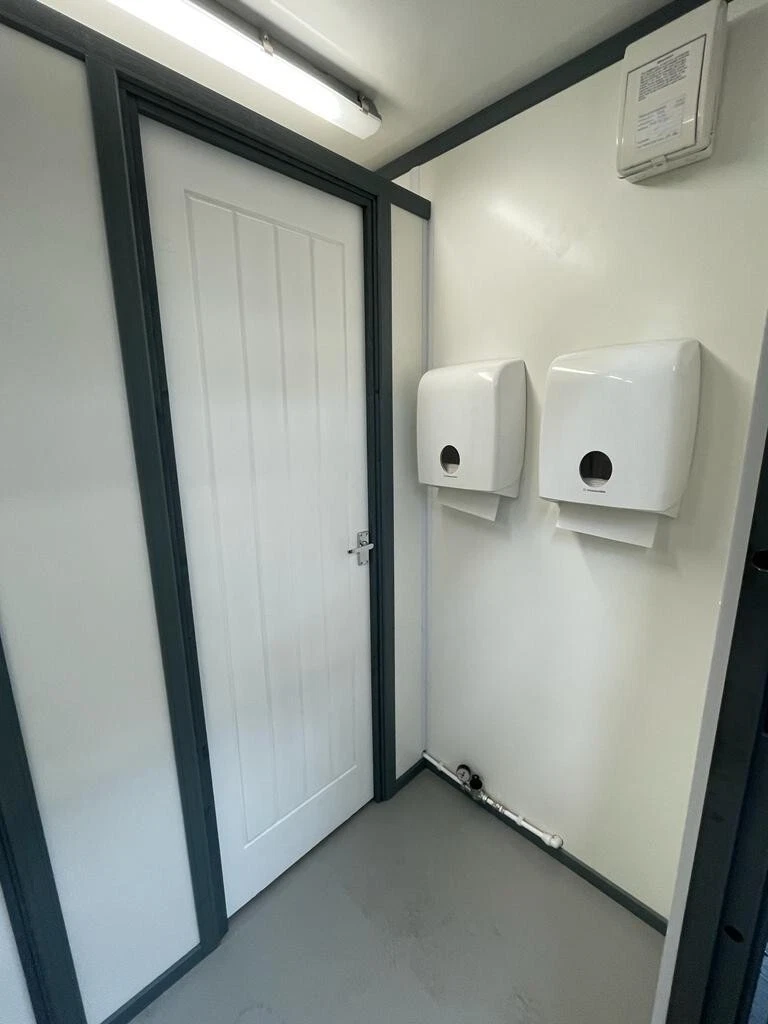 Modular toilet block built from a 20ft corten steel shipping container