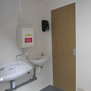Site welfare toilet cabin with male and female sections and water heaters