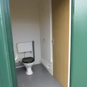 Portable steel restroom cabin for industrial and construction environments