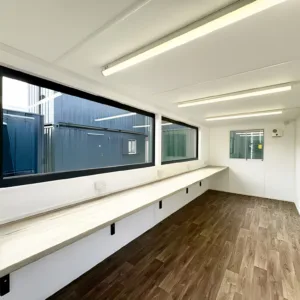 Portable canteen unit with insulated walls and modern workspace design