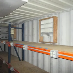 Container office with built-in shelving, electrical installation, and workspace