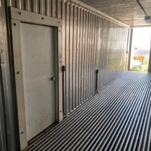 Commercial refrigerated shipping container with insulated walls and side door