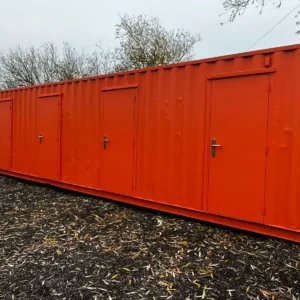 Multi-compartment shipping container with secure side access doors