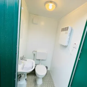 Green double mains toilet cabin with wash basins and extractor fan