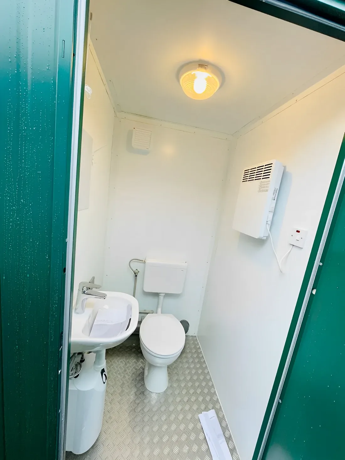 Green double mains toilet cabin with wash basins and extractor fan