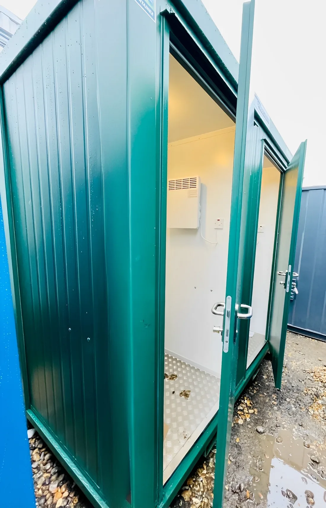 Insulated portable toilet cabin with two toilets and hand wash basins