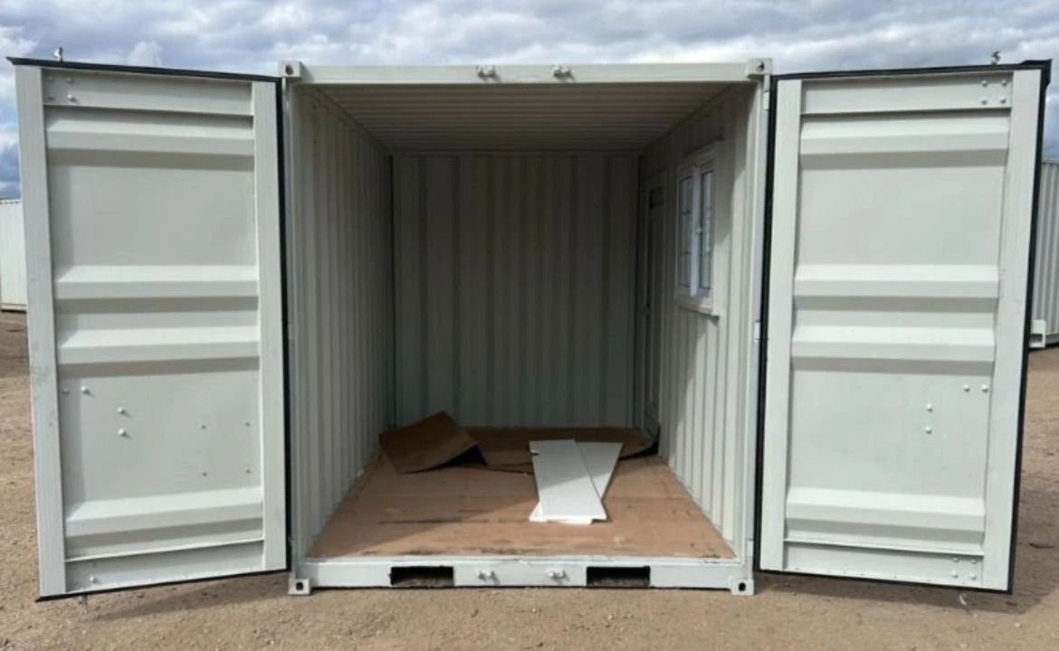 Portable workspace container with window and secure personnel door
