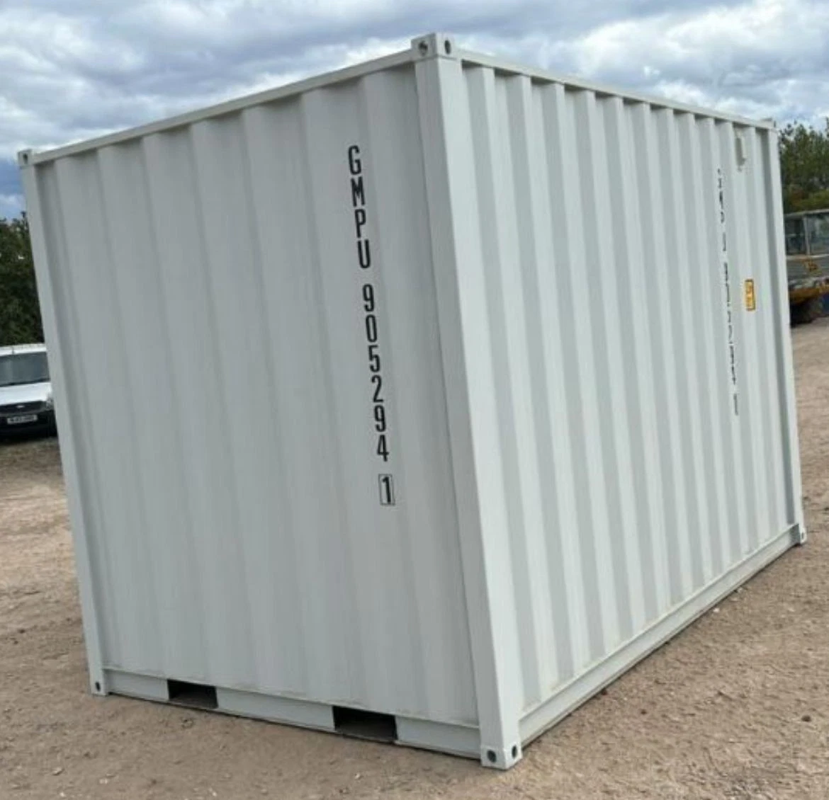 Small shipping container office with side access door and rear cargo doors