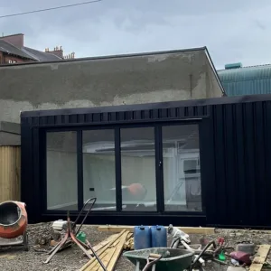 20ft container home office with full-width sliding glass patio doors