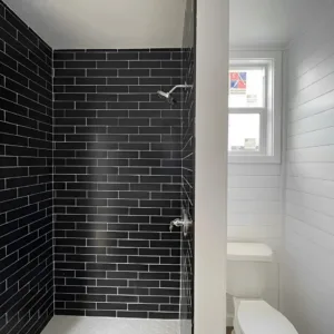 One-bedroom shipping container home with glass patio doors and premium finishes