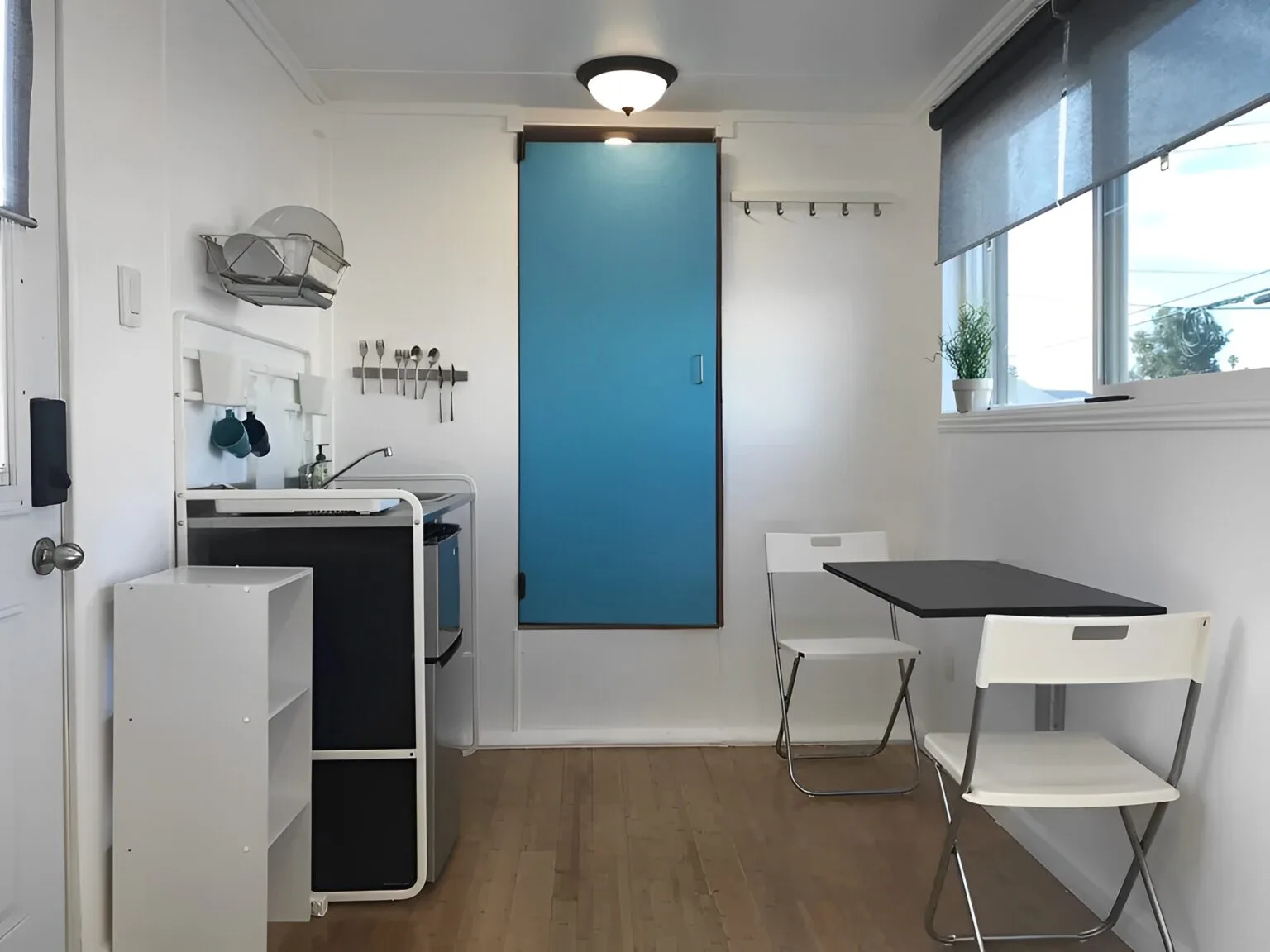 Modern tiny home built from a 20ft shipping container with large windows