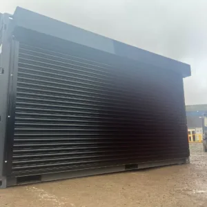 Modified shipping container with motorized roller shutter side door