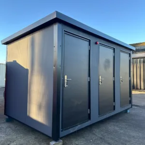Shipping container restroom facility with three lockable toilet cubicles