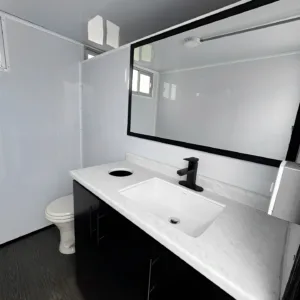 Mobile restroom trailer with two RV toilets and climate-controlled interior